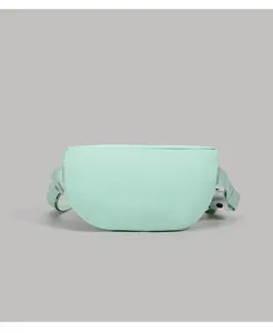 Front detail of a mint green half-moon crossbody bag in high-density canvas fabric