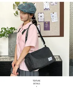 Detail showing side zipper pocket and texture on a black canvas commuter bag