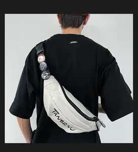 Rear view of model wearing off-white canvas chest bag with badges on black strap