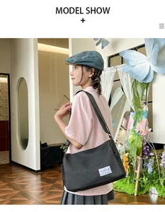 Lifestyle model shot of black large capacity canvas crossbody bag for daily casual outfits