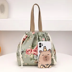 Sac à lunch floral en toile avec motif de roses vertes et poignées marron robustes
