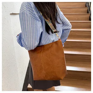 Detail of vintage brown tote bag featuring ethnic pattern embroidery wide shoulder strap