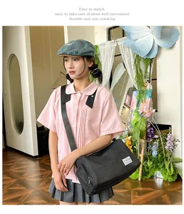 Detail of black canvas messenger bag with adjustable strap and side zipper pocket