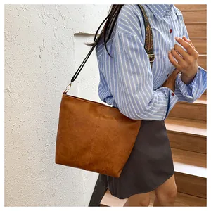 Close-up of brown vintage tote bag featuring ethnic style embroidered wide shoulder strap