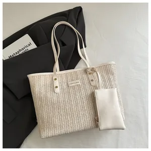 Detail of the woven straw tote bag with white leather trim and a matching small coin purse
