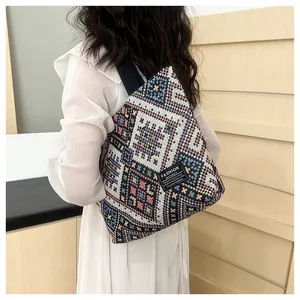 Detailed close-up of colorful ethnic woven tote bag with geometric diamond patterns