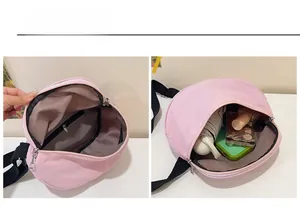 Internal view of pink crescent bag showing main compartment and zippered pocket capacity