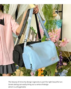 Detail showing spacious light blue canvas bag with side zipper and adjustable shoulder strap