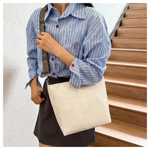 Detail of off-white tote bag with a colorful bohemian patterned wide shoulder strap
