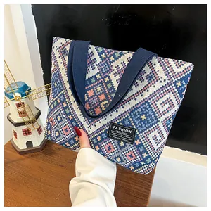 Detailed texture of ethnic patterned fabric tote bag with premium leather logo tag