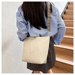 Detail of beige faux leather tote with wide vintage geometric jacquard shoulder strap