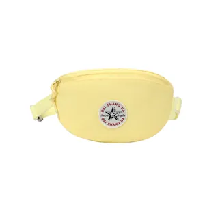 Pale yellow nylon waist bag with adjustable strap and front circular logo on white background