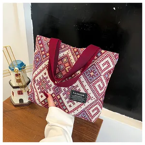 Detail of a large ethnic tote bag featuring red and blue geometric woven patterns