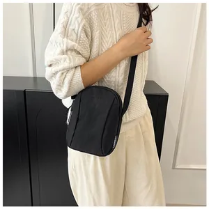 Detail of black waterproof nylon crossbody bag featuring Lanweier logo and adjustable strap