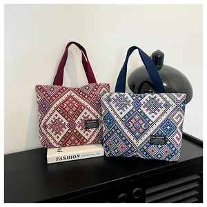 Detail of woven jacquard tote bags with ethnic geometric patterns in red and blue
