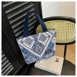 Close-up of ethnic geometric pattern weaving and FASHION tag on the tote bag