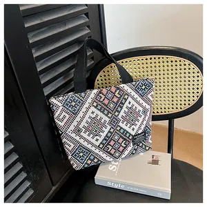Ethnic canvas tote bag with geometric patterns and fashion tag on a chair