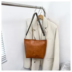 Detail of vintage brown tote bag with wide ethnic geometric pattern shoulder strap