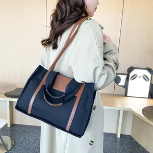 Canvas and brown leather tote bag with long shoulder straps for stylish daily commute