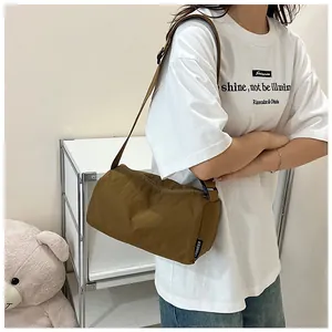 Detailed side view of the brown nylon cylinder bag featuring the LANWEIER woven label