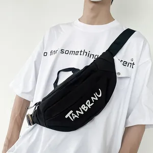 Minimalist black canvas chest bag with white TANBRNU print and adjustable shoulder strap