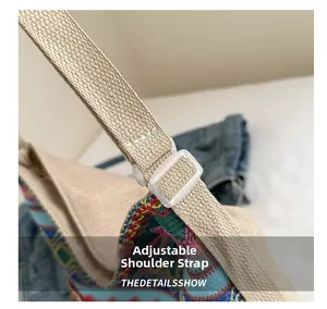 Detail of ethnic canvas bag showing the adjustable beige strap and resin buckle