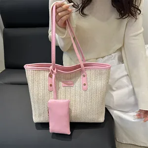Large beige woven straw tote bag with pink leather trim and matching small coin purse charm