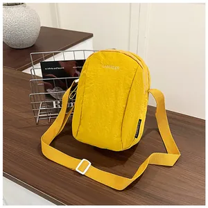 Detail of yellow nylon crossbody bag with LANWEIER logo and adjustable wide strap