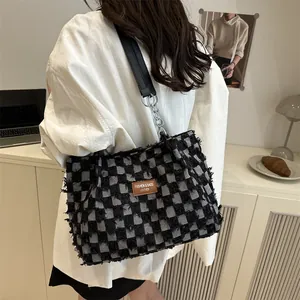 Sac fourre-tout à damier noir et blanc avec texture tissée et bandoulière en chaîne