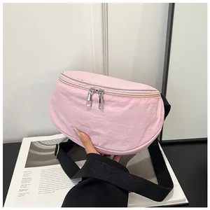 Close-up of pink crescent saddle bag showing durable nylon texture and silver zippers