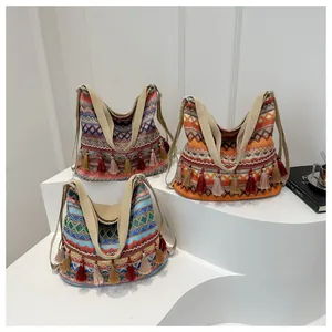 Detailed view of bohemian woven bags featuring ethnic patterns and colorful tassels