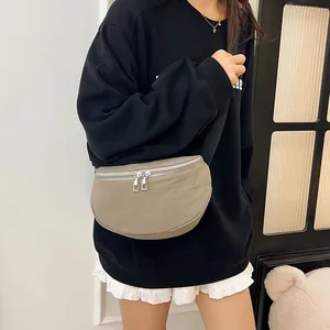 Versatile beige half-moon crossbody bag made of durable nylon with adjustable black strap