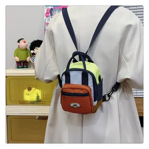 Detailed close-up of a multi-color mini backpack with adjustable straps worn by a model