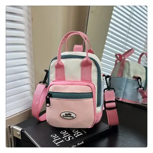 Detailed shot of multi-way mini canvas bag in beige and pink with mirror reflection