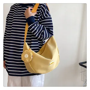 Detailed view of yellow nylon crescent bag with matching round coin pouch and wide strap