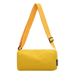 Large bright yellow nylon crossbody bag with adjustable wide strap and minimalist style