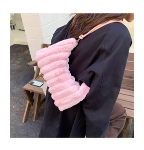 Detail of soft pink faux fur tote bag showing the unique layered stripe texture and shoulder strap