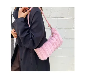 Detail of pink faux fur tote bag showing horizontal pleated texture and leather straps