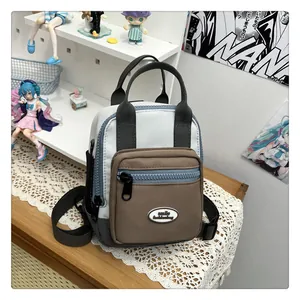 Close-up of tricolor patchwork backpack with smile fashionbag logo and front pocket