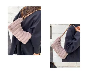 Detail of light purple plush tote bag with horizontal texture and slim leather straps