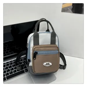 Detailed close-up of mini canvas crossbody bag with contrast stitching and smile logo