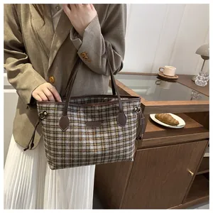 Detailed shot of retro plaid tote bag with premium leather handles and drawstring accents