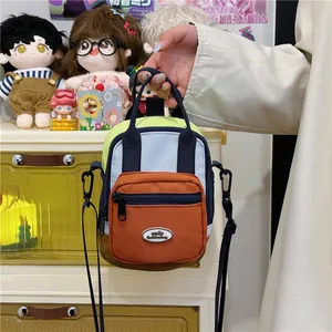 Colorful patchwork crossbody bag with orange front pocket and smile fashion logo
