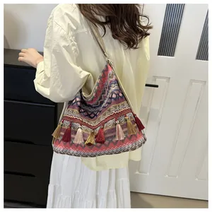 Close-up of bohemian tote bag with colorful geometric patterns and decorative fringe