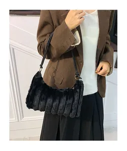 Detail of black faux fur tote bag showing plush striped texture and leather strap