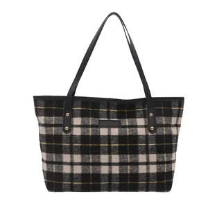 Large plaid tote bag with black handles and yellow accents for autumn winter fashion