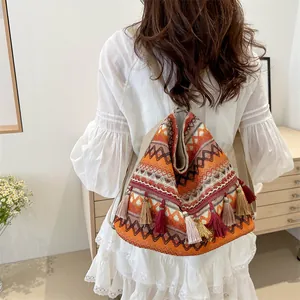 Ethnic woven backpack with geometric patterns and colorful tassels for travel and commute