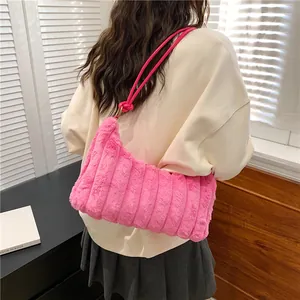 Fashionable bright pink plush tote bag with vertical stripe texture and leather strap