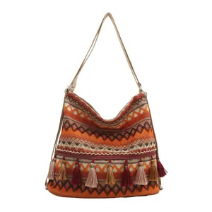 Ethnic bohemian woven shoulder bag with geometric patterns and colorful tassels