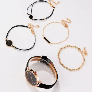 Close-up of 5-piece women's set with black PU leather watch and four gold bracelets